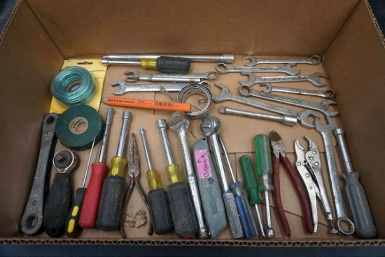 Box of tools, ratchets, wrenches, vice grips, wire, and more.