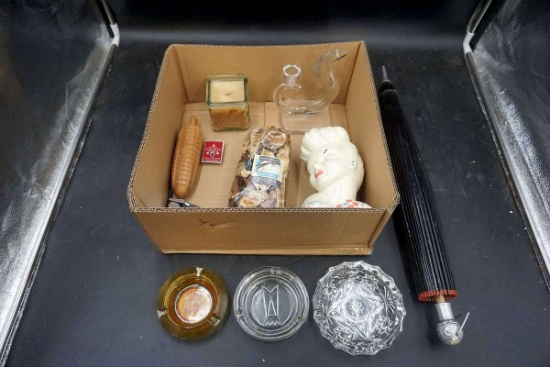 Ashtrays, parasol, head vase, candles. Corn.
