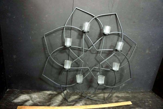 Metal art with candle holders.
