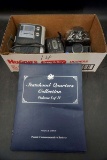 State quarters collection, vintage cameras, cassette player, weather radio.