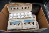 Box full of golf balls.