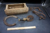 Trap, bits, horseshoe, brush, wooden box.