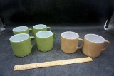 Green and brown coffee cups.