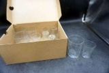 Box full of glassware. Clear glass cups.