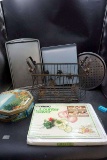Metal basket, cutting board, pans, tin canister.