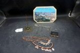 Receipt spike, costume jewelry, Grand Canyon souvenir, blush compact.