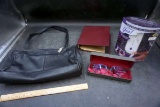 Handbag, binder, glasses, finishing touch hair remover.