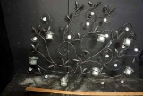 Metal art with candle holders.