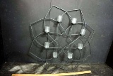 Metal art with candle holders.