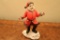 Porcelain Santa with a pipe and cane. Plays 