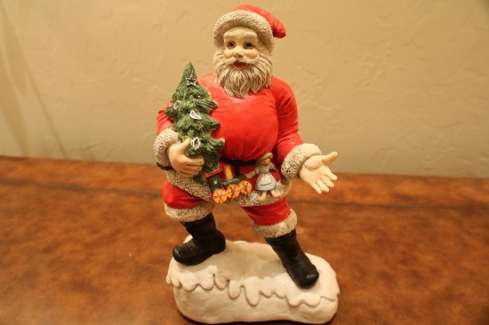 Porcelain Santa with Christmas Tree in hand. Plays "Jingle Bells" "11 3/4"