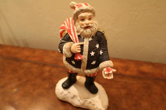 Porcelain Santa wearing American flag colors. Plays "We Wish You A Merry Christmas" 12"
