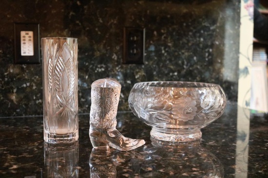 A crystal glass, boot, and decorative bowl