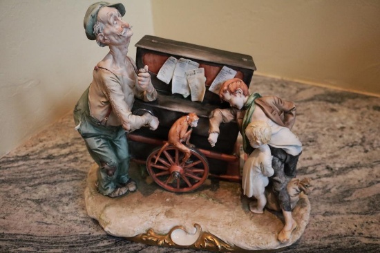Porcelain piece of two boys, a man, and a monkey on a wagon, Italian