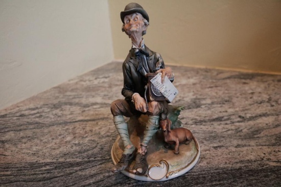 Porcelain piece of a man sitting smoking his pipe alongside his dog, G Cappe 99006 Italy