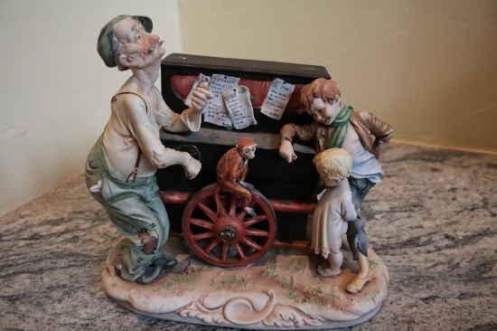 Porcelain piece of two young boys, a man, and a monkey. (Possible replica of Image #0482),