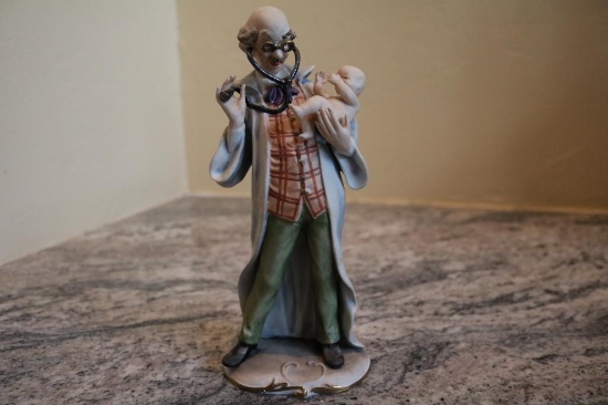 Porcelain piece of a doctor checking a baby, no. 3798