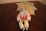 Clown posing with umbrella