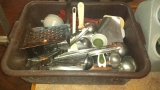 Bus pan full of ladles, cheese grater, fry scoop and more