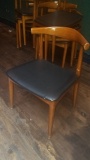 Wooden dining room chair with blue vinyl cushion seat