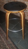 Wooden bar stool with black vinyl cushion seat