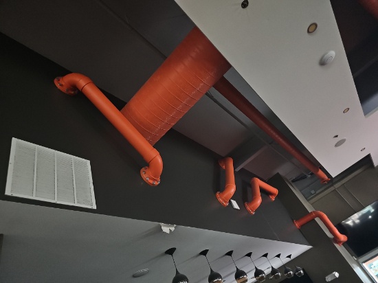 Faux Orange pipes coming from wall