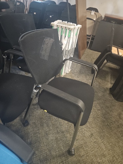 Black office chairs with chrome legs and cushion seat