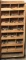 Large wooden pigeonhole drill bit shelf with 21 'holes' of used and some ne