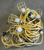 (2) strings 50' each of used yellow cord stringer work lights with cages