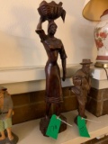 WOOD CARVING OF A LADY W/ LAUNDRY ON HER HEAD