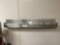 two stainless steel wall racks and utensil rack