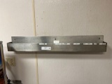 two stainless steel wall racks and utensil rack