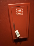 fire extinguisher in red metal wall mount case