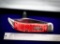 Case with jigged synthetic handle with large clasp, tested XX, blade approximately 4.5 in and 9.5 in