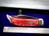 Case with jigged synthetic handle with large clasp, tested XX, blade approximately 4.5 in and 9.5 in
