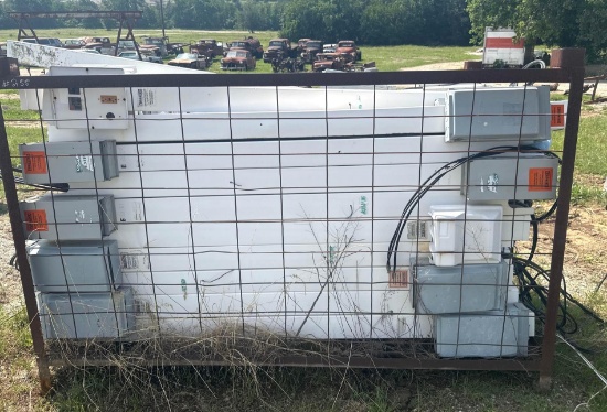 Rack of Old Electrical Boxes on Poles