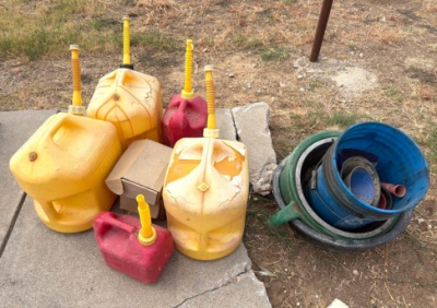 Five Gas Cans with Oil Drain Pans and Funnels