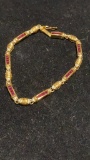 18ct gold bracelet with ruby & dimond & matching earrings. Weights 18 grams