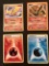 4 Pokemon Cards Moltres Level 42 Card Ho-Oh 2 Energy Cards with Pokemon Shadows in the Background