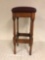 Old wooden bar stool with cushion top