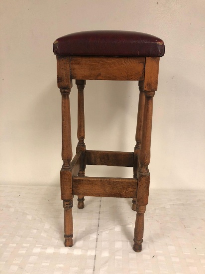Old wooden bar stool with cushion top