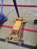 Yellow hydraulic floor jack