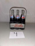 6pk of full Pepsi- Cola bottles in holder
