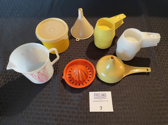 Large group of Tupperware and vintage measuring cups