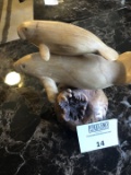 Large carved wooden sea lions