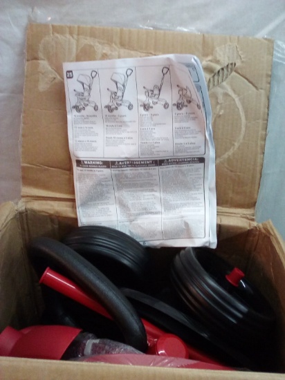 4-in-1 Red Stroller unassembled in the box as seen in the box