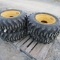 (4) NEW 12-16.5 SKID STEER TIRES ON YELLOW RIMS - ALL ONE PRICE