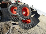 (4) NEW 12-16.5 ORANGE SKID STEER TIRES AND RIMS - ALL ONE PRICE