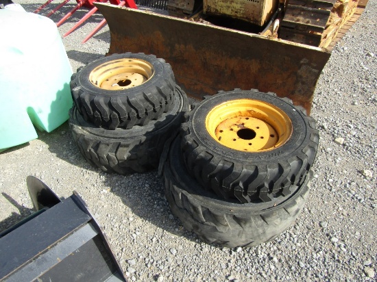 (4) SKID STEER TIRES AND RIMS