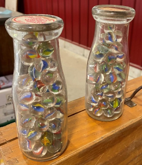 2 GLASS BOTTLES WITH MARBLES